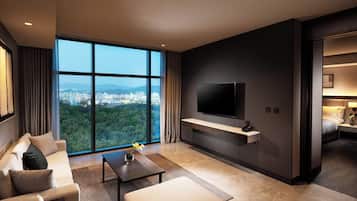 Deluxe, One Bedroom Suite, Forest View | Living area | 55-inch flat-screen TV with cable channels, TV, pay movies