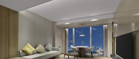Una sala de estar moderna con sofá, mesa de centro y televisor.