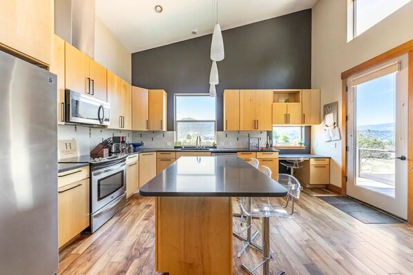 Enjoy meals in the kitchen with a sleek island and stainless steel appliances.