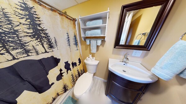 A bathroom with a toilet, sink, and towel rack. - Lakeside Loft (Direct Access to Moosehead Lake!) (Greenville)