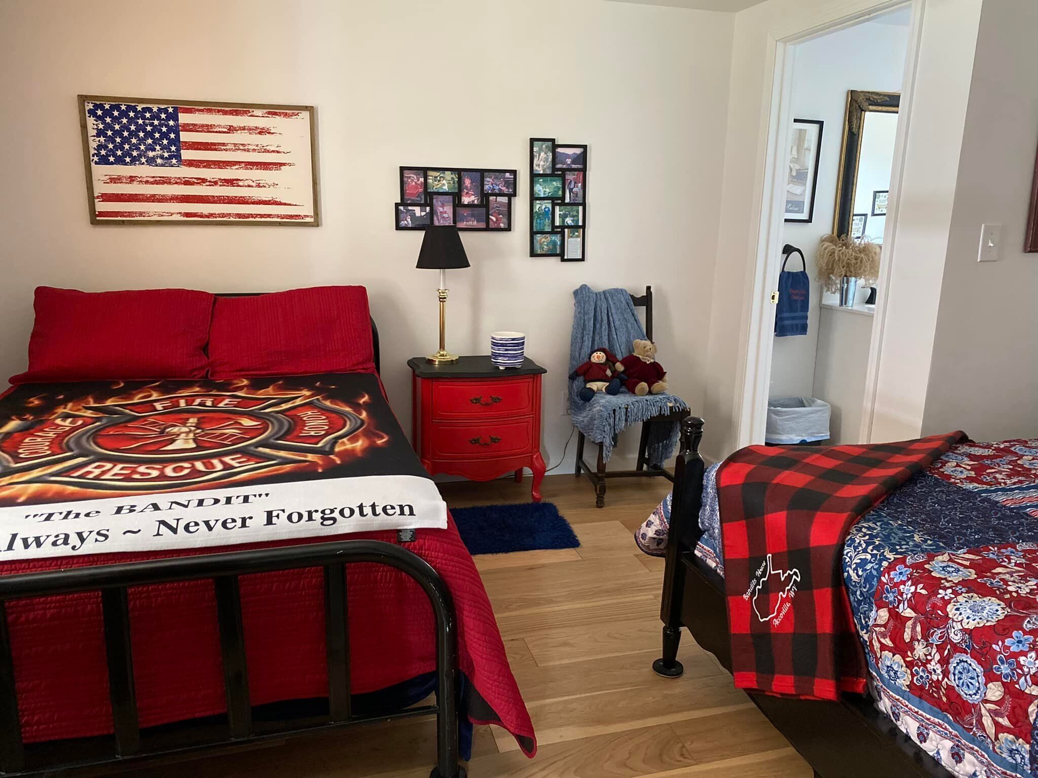 A bedroom with two beds, a dresser, a lamp, and a teddy bear.