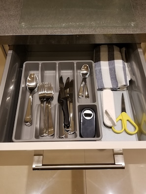 Kitchen essentials at your fingertips, including silverware and utensils.