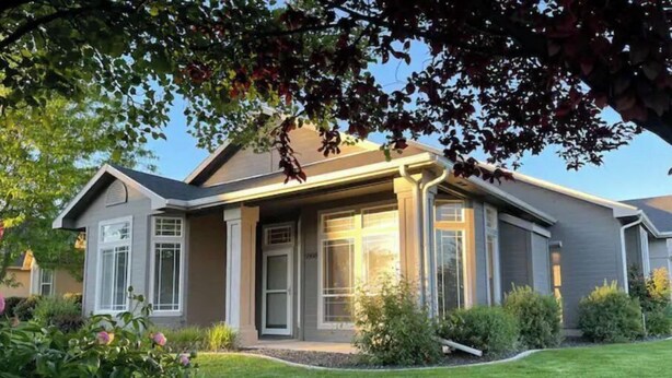 A modern two-story house with a well-maintained lawn and flowering plants. - Luxury 3BR Home, Comfy 🛌, WiFi, Quiet, Near (Boise)