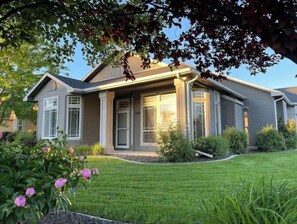 A modern two-story house with a well-maintained lawn and flowering plants. - Luxury 3BR Home, Comfy 🛌, WiFi, Quiet, Near (Boise)