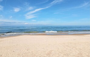 A beach with a clear sky and calm sea.