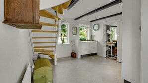 A spacious interior with a staircase, a kitchen area, and a dining space. - 5 bedroom awesome home in Erslev (Erslev)