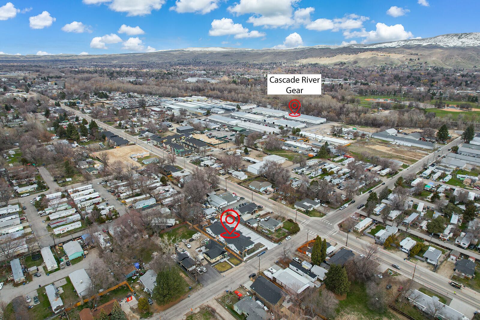 An aerial view of a residential area with a large industrial complex labeled 'Cascade River Gear'.