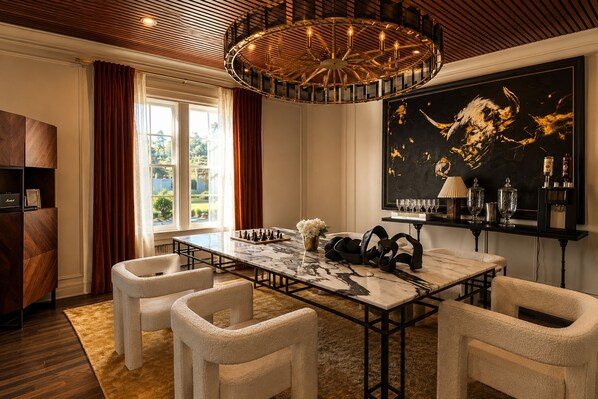 A dining area with a marble table, four chairs, a chandelier, a large abstract painting, and a bar area with glasses and bottles. - A two-level loft with comfortable furnishings, warm interiors, and a fireplace that adds a cozy focal point to the living space, with the pool just outside.🎡 STAY MINUTES FROM THE STATE FAIR OF TEXAS! 🎡 (Dallas)