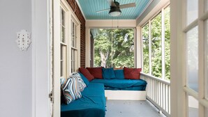 A covered porch with a built-in bench and a ceiling fan. - The Hawksbill Haus (w/ hot tub) (Waynesboro)