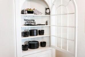 A white arched display cabinet with black bowls and a sign that reads "Still Remember the Good Days." - Cheerful Colonial in Historic Olde Wythe, Hampton, VA (Hampton)