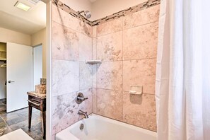 A bathroom with a bathtub, a shower, and a tiled wall. - Patio & Panoramic Desert Views: Sedona Getaway! (Sedona)