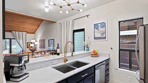 A modern kitchen with a double sink, a coffee machine, and a refrigerator. - RMR: Cinquefoil 1612 Condo in The Aspens/Wilson,WY (Wilson)