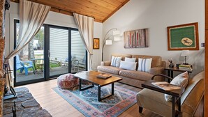 A cozy living room with a wooden ceiling, a sofa, a coffee table, and a rug. - RMR: Cinquefoil 1612 Condo in The Aspens/Wilson,WY (Wilson)