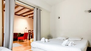 Ett hotellrum med en säng, en stol och ett litet bord.