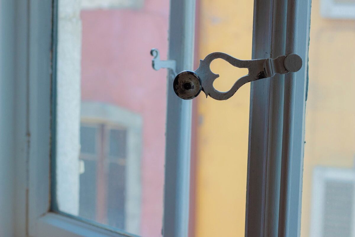 A window with a metal latch.