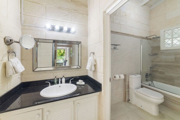 A bathroom with a sink, mirror, and shower. - Amazing 3-bed Villa 5 mins from Beach - Palm Grove 1 (Mullins)