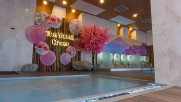 A swimming pool area with a sign reading "The Yana Onsen".