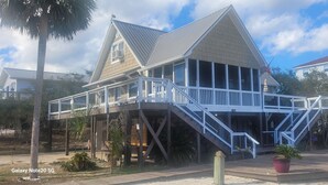 A two-story house with a balcony and a staircase leading to the upper floor. - Beach Getaway Just Refreshed, Sleeps 8 <4 br> EV level 2 charging- views (Alligator Point)