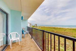 Enjoy the ocean view from this balcony with a clear view of the beach and surrounding landscape.