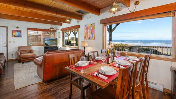 A dining area with a table set for six, overlooking the ocean. - New Listing! Cozy beachfront home on famed Heceta Beach, amazing sunsets (Florence)