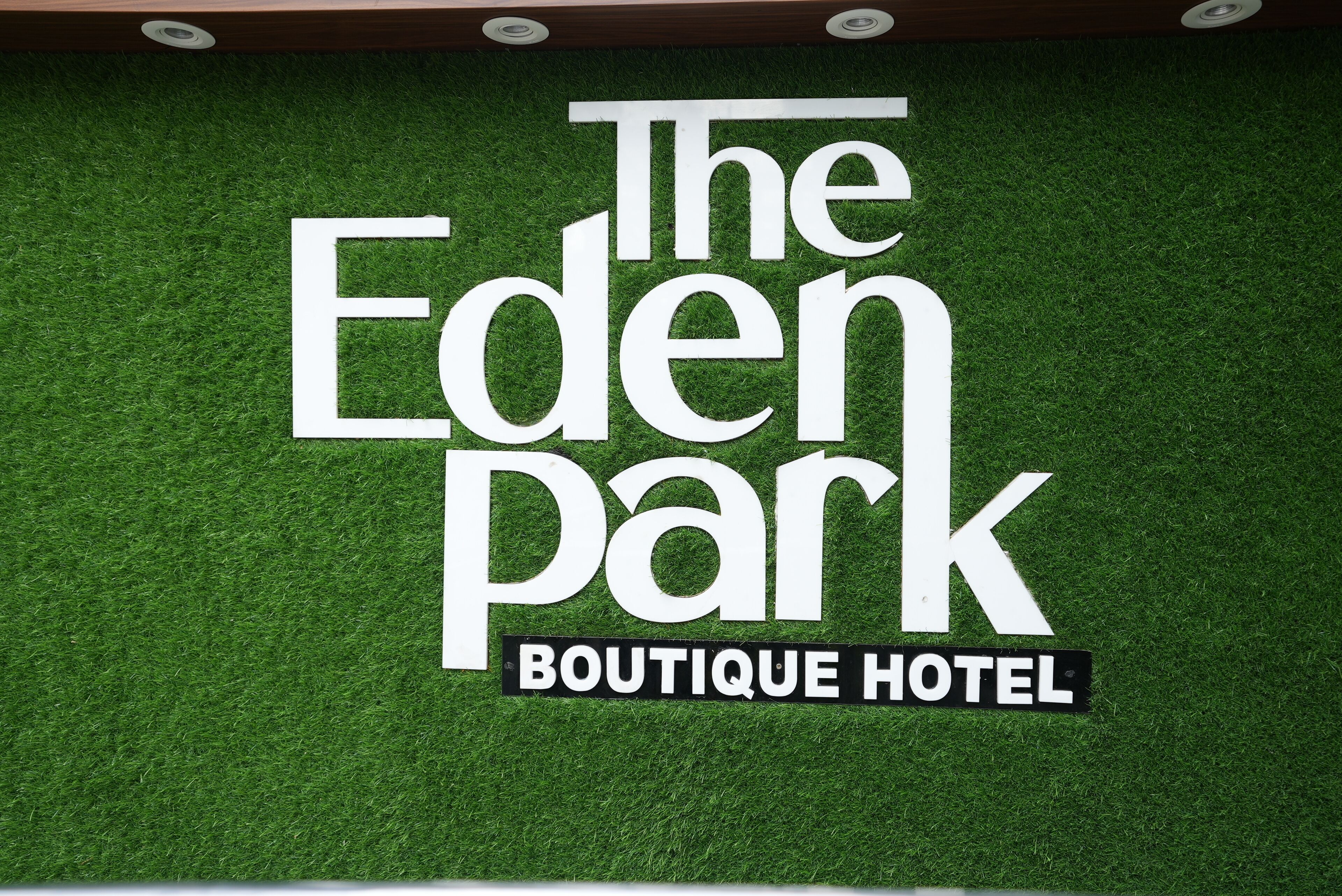 A sign for 'The Eden Park Boutique Hotel' with a modern design.