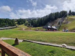 A ski resort with a chairlift, a small building labeled 'Lovatier,' and a stone structure in the foreground.