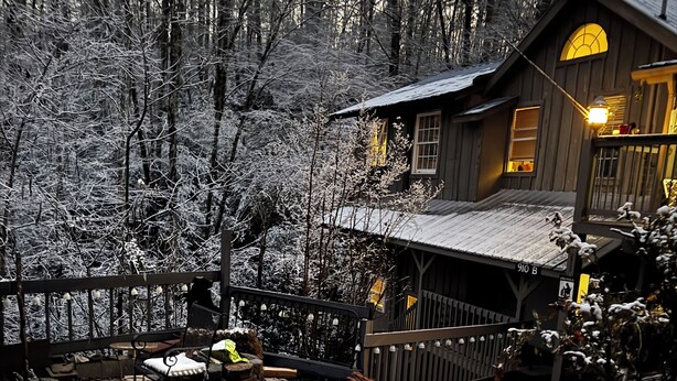 A rustic cabin with a wooden deck and a snow-covered yard. -  Amazing Suite w Fireplace & Washer & Dryer! Pets & 420 Friendly (Gatlinburg)