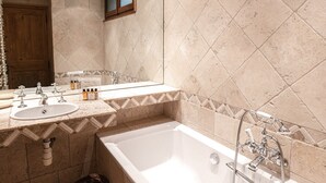 A modern bathroom with a bathtub, a sink, and a vanity mirror. - Typical Chalet in Chamonix with Parking and Wifi, Near Center and Slopes (Chamonix-Mont-Blanc)