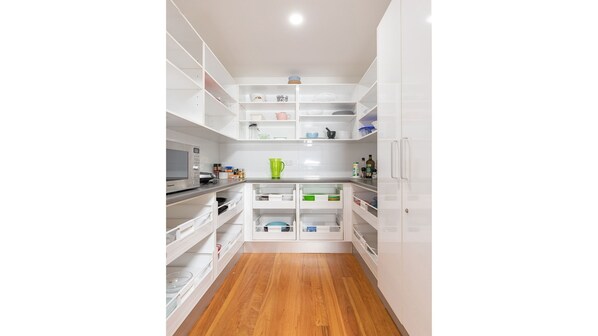 Enjoy cooking in this well-equipped kitchen with microwave, coffee maker, and ample storage.