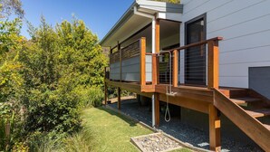 A modern house with a wooden deck, a covered outdoor area, and a garden with various plants. - Seaclusion ... walk to the Beach, Lake or the The Recky! (Elizabeth Beach)