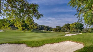A golf course with sand bunkers, trees, and a clear sky. - Amazing home in Dehesa de Campoamor (Dehesa de Campoamor)