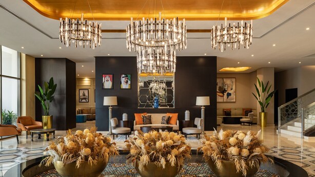 A modern lobby with a central seating area, chandeliers, and decorative vases. - Four Points by Sheraton Production City, Dubai (Dubai)