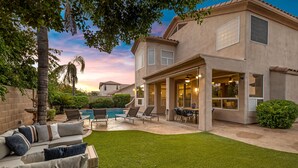 A residential property with a backyard featuring a swimming pool, outdoor seating, and a covered patio area. - Sweet Escape l Heated Pool l Luxury Living (Scottsdale)