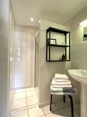 Shower, hair dryer, towels, soap