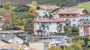 A residential area with multi-story buildings, some with balconies, and a hillside in the background. - Apartments Marialisa Superior 'Apt Rose' with Mountain View, Whirlpool & Wi-Fi (Chiusa)