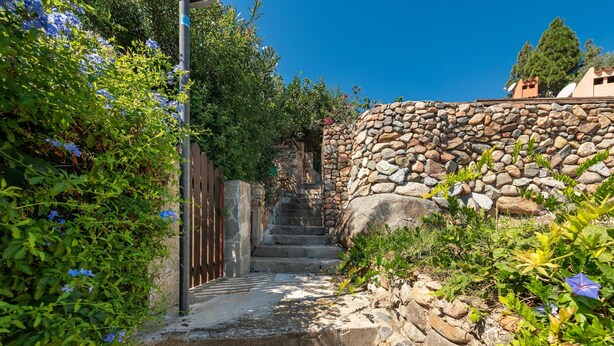 A stone staircase leading up to a building, surrounded by greenery and a clear blue sky. - Holiday Home 'Bianca' with Sea View, Private Terrace and Air Conditioning (Costa Rei)