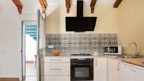 A kitchen with a gas stove, oven, microwave, and a sink. - Pet-Friendly 'Apartment en la Playa 2' with Terrace & Wi-Fi (Conil de la Frontera)
