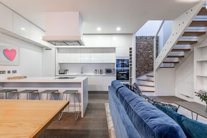 Enjoy cooking and dining in this kitchen with a microwave, island, and large window offering a view of the adjacent living area.