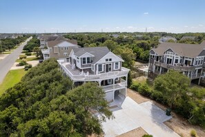 A residential area with detached houses featuring large front porches and multiple stories.