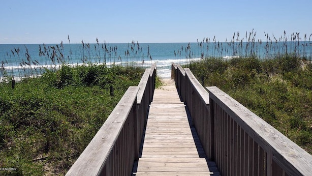 A wooden boardwalk leading to the beach with clear skies. - Summer Wynd | Ocean Views + Community Amenities! (North Topsail Beach)