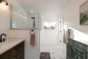 Bathtub, hair dryer, towels, toilet paper