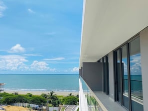 Enjoy breathtaking views of the ocean from this property's expansive balcony with large windows.