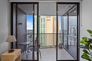Enjoy the city view from your balcony with a table and chairs.
