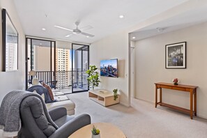 Relax in this stylish living room with a city view, featuring a flat-screen TV and comfortable seating area.