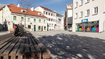 A bench in a public square with buildings in the background.