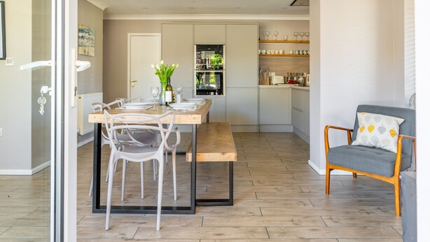 Una cocina moderna con comedor, banco y silla.