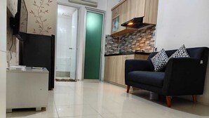 Basic Apartment | Living area | 32-inch flat-screen TV with digital channels, TV - Toptravel Bassura City (Jakarta)