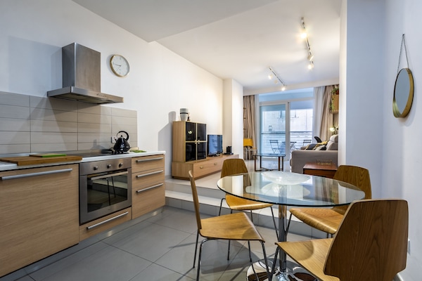 Spacious Living dining leading onto a balcony with side sea views.