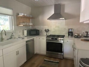 Effortlessly prepare meals in this well-equipped kitchen with a range, microwave, and coffee maker.