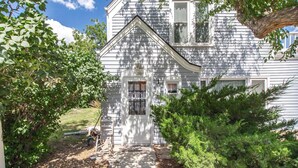 A white house with a front porch, a small shed, and a tree in front. - Historic District, Downtown, STE 1 (Rapid City)